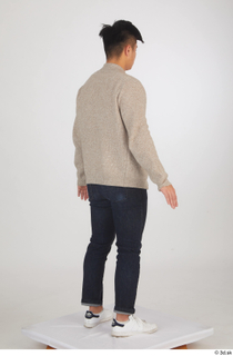 Yoshinaga Kuri blue jeans brown sweater casual dressed standing white…